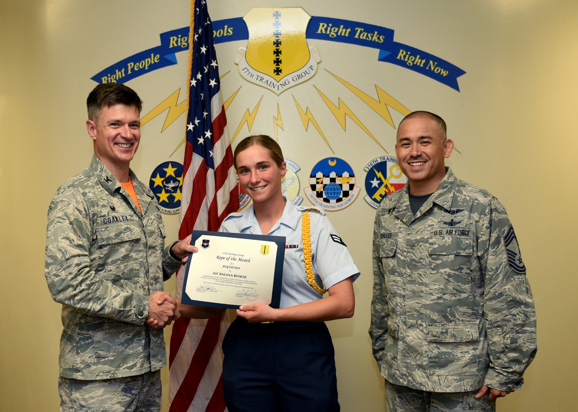 U.S. Air Force Col. Thomas Coakley, 17th Training Group commander, presents the 17th TRG Rope of the Month award to Airman 1st Class Raeana Bedker, 315th TRS student, at Brandenburg Hall on Goodfellow Air Force Base, Texas, September 6, 2019. Military Training Leaders present ropes to Airmen who display exceptional leadership qualities to lead their peers. (U.S. Air Force photo by Airman 1st Class Robyn Hunsinger/Released)