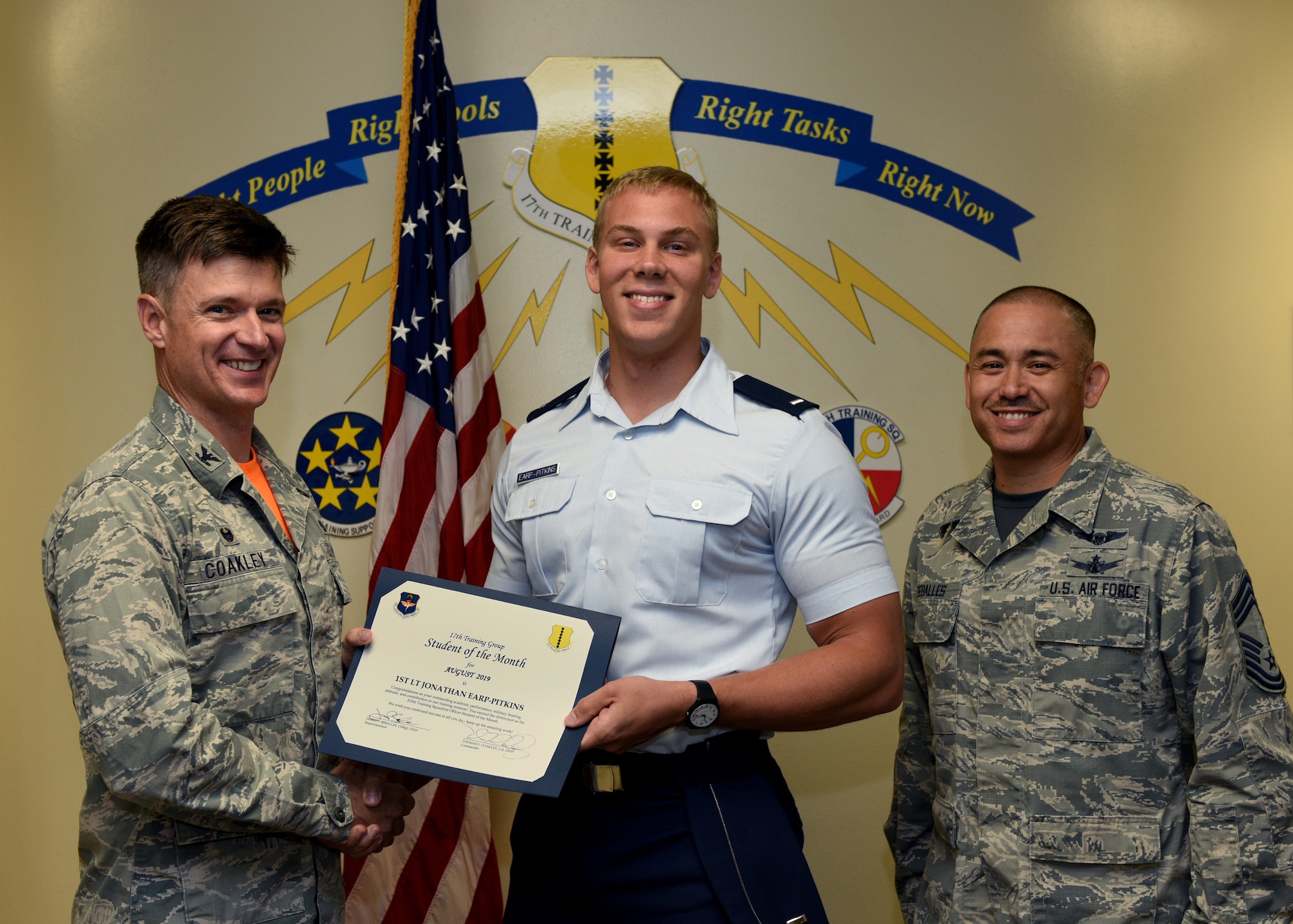U.S. Air Force Col. Thomas Coakley, 17th Training Group commander, presents the 315th Training Squadron Student of the Month award to 1st Lt. Jonathan Earp-Pitkins, 315th TRS student, at Brandenburg Hall on Goodfellow Air Force Base, Texas, September 6, 2019. The 315th TRS’s vision is to develop combat-ready intelligence, surveillance and reconnaissance professionals and promote an innovative squadron culture and identity unmatched across the U.S. Air Force. (U.S. Air Force photo by Airman 1st Class Robyn Hunsinger/Released)