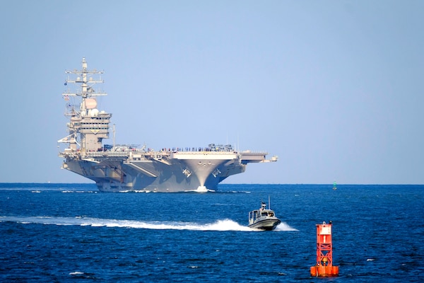 An aircraft carrier floats on the ocean.