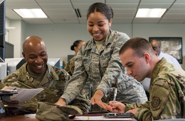 Chief Master Sgt. of the Air Force Kaleth O. Wright outprocesses Senior Airman R. Tyler Thompson, 436th Maintenance Squadron aircraft maintenance journeyman, Sept. 3, 2019, at Dover Air Force Base, Del. Airman 1st Class Lauren Lewis, 436th Force Support Squadron career development technician, guided Wright through the entire process. (U.S. Air Force photo by Roland Balik)