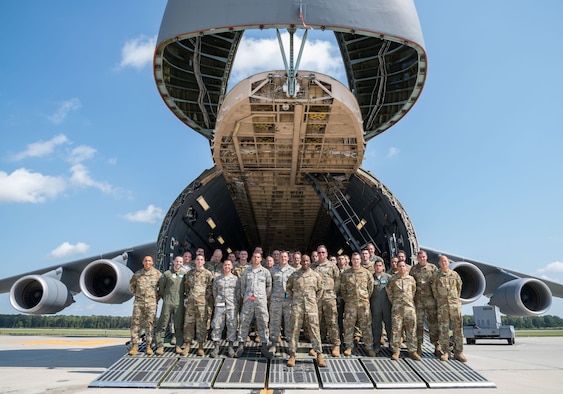 Chief Master Sgt. of the Air Force Kaleth O. Wright poses for a photo with aircrew and maintenance personnel on the forward ramp of a C-5M Super Galaxy Sept. 4, 2019, at Dover Air Force Base, Del. Wright visited aircrew members and maintenance personnel during a two-day visit. (U.S. Air Force photo by Roland Balik)