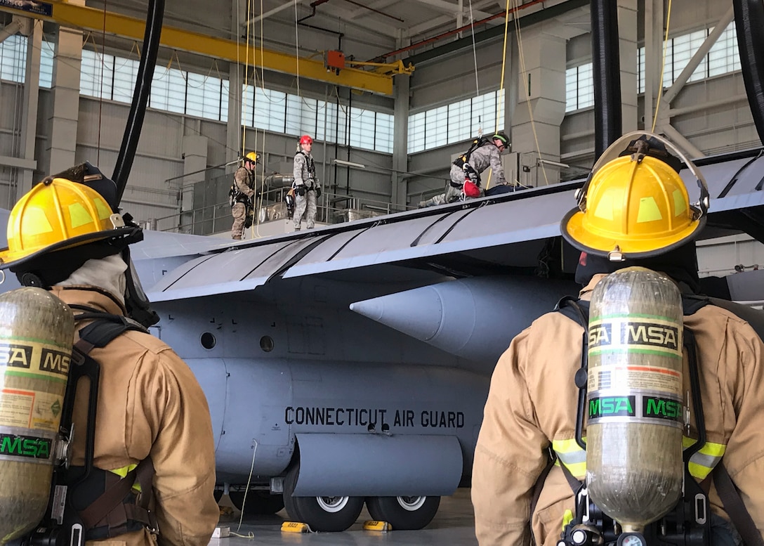 Firefighters from the 103rd Civil Engineer Squadron remove a simulated maintainer from a C-130H Hercules fuel tank during a confined space rescue exercise at the fuel cell and corrosion control facility, Bradley Air National Guard Base, East Granby, Conn. Sept. 8, 2019.