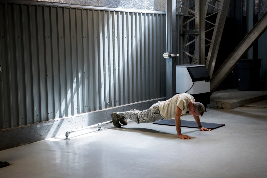 An Airman performs pushups Aug. 28, 2019, at Dover Air Force Base, Del. Prior to the completion of the new gym, Airmen only had a few mats and a toe bar to perform physical training activities close to their work center. (U.S. Air Force photo by Senior Airman Christopher Quail)