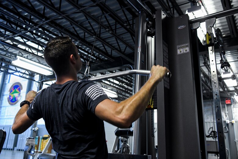 Staff Sgt. Jacob Miller, 436th Aircraft Maintenance Squadron communication navigations and electronic warfare journeyman, exercises Sept. 3, 2019, at Dover Air Force Base, Del. Prior to the completion of the new gym, Airmen only had a few mats and a toe bar to perform physical training activities close to their work center. (U.S. Air Force photo by Senior Airman Christopher Quail)