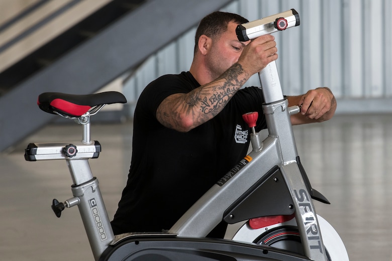 A Sourcelinq LLC fitness technician assembles a speed bike Aug. 28, 2019, at Dover Air Force Base, Del. The gym was assembled in two days and cost approximately $80,000. (U.S. Air Force photo by Senior Airman Christopher Quail)