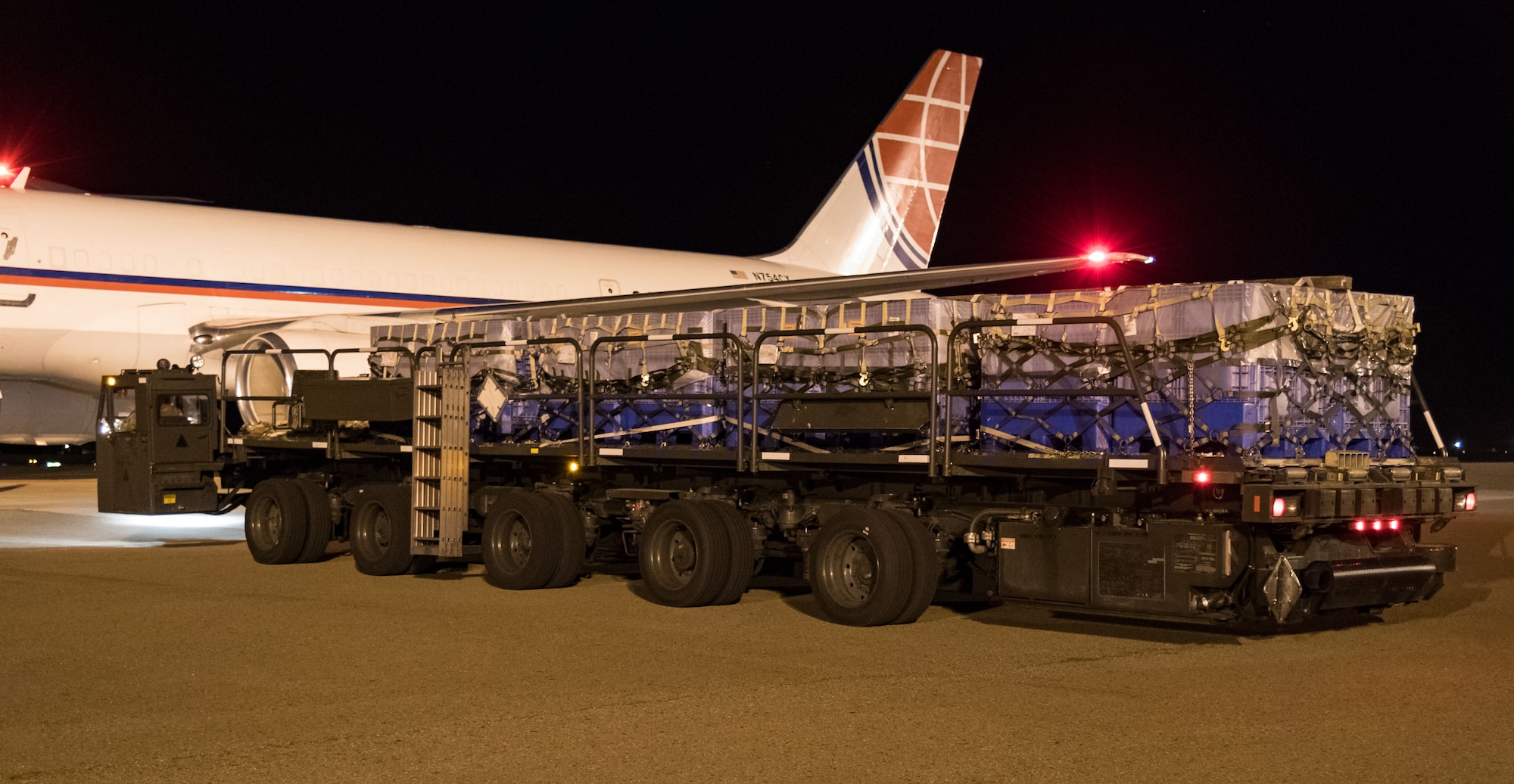 A K-loader with five pallets waits to be marshalled into position by 436th Aerial Port Squadron ramp services personnel Sept. 8, 2019, at Dover Air Force Base, Del. The Air Transport International Boeing 757-200 aircraft, part of the Civil Reserve Air Fleet program, was contracted to transport cargo pallets and 30 Team Dover members to Fairchild AFB, Wash., participating in Mobility Guardian 2019. “In support of exercise Mobility Guardian 2019, Air Mobility Command contracted commercial aircraft to simulate activating CRAF marking the first time, in a long time, AMC has exercised a commercial component of its wartime plan,” said Maj. Adam Crane, AMC Headquarters CRAF Branch Chief, Scott AFB, Ill. (U.S. Air Force photo by Roland Balik)