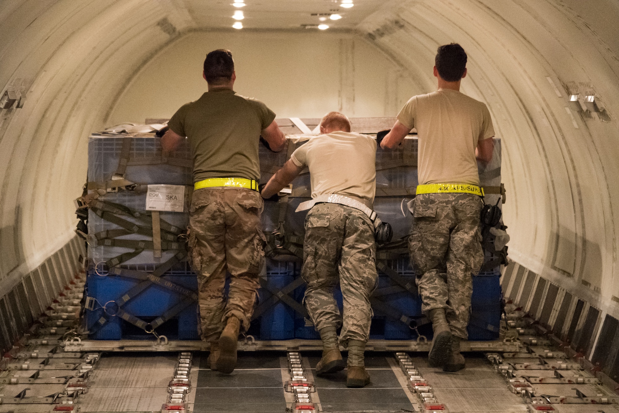 Members of 436th Aerial Port Squadron ramp services section push a pallet into its position in the main cargo deck of an Air Transport International Boeing 757-200 aircraft Sept. 8, 2019, at Dover Air Force Base, Del. The ATI aircraft, part of the Civil Reserve Air Fleet program, was contracted to transport cargo and 30 Team Dover members to Fairchild AFB, Wash., participating in Mobility Guardian 2019. “We welcome the inclusion of one of our CRAF partners in MG19 as it marks the first time Air Mobility Command has exercised a commercial airlift component of our wartime plan,” said Maj. Adam Crane, AMC Headquarters CRAF Branch Chief, Scott AFB, Ill. (U.S. Air Force photo by Roland Balik)