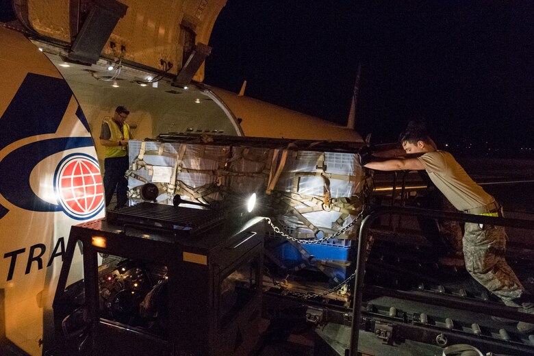 Senior Airman Brandon Sanderell, 436th Aerial Port Squadron ramp services specialist, pushes a pallet onto an Air Transport International Boeing 757-200, as Brian McDonald, senior loadmaster, watches it enter the aircraft Sept. 8, 2019, at Dover Air Force Base, Del. The ATI aircraft, part of the Civil Reserve Air Fleet program, was contracted to transport cargo and 30 Team Dover members to Fairchild AFB, Wash., participating in Mobility Guardian 2019. “In support of exercise Mobility Guardian 2019, Air Mobility Command contracted commercial aircraft to simulate activating CRAF marking the first time, in a long time, AMC has exercised a commercial component of its wartime plan,” said Maj. Adam Crane, AMC Headquarters CRAF Branch Chief, Scott AFB, Ill. (U.S. Air Force photo by Roland Balik)