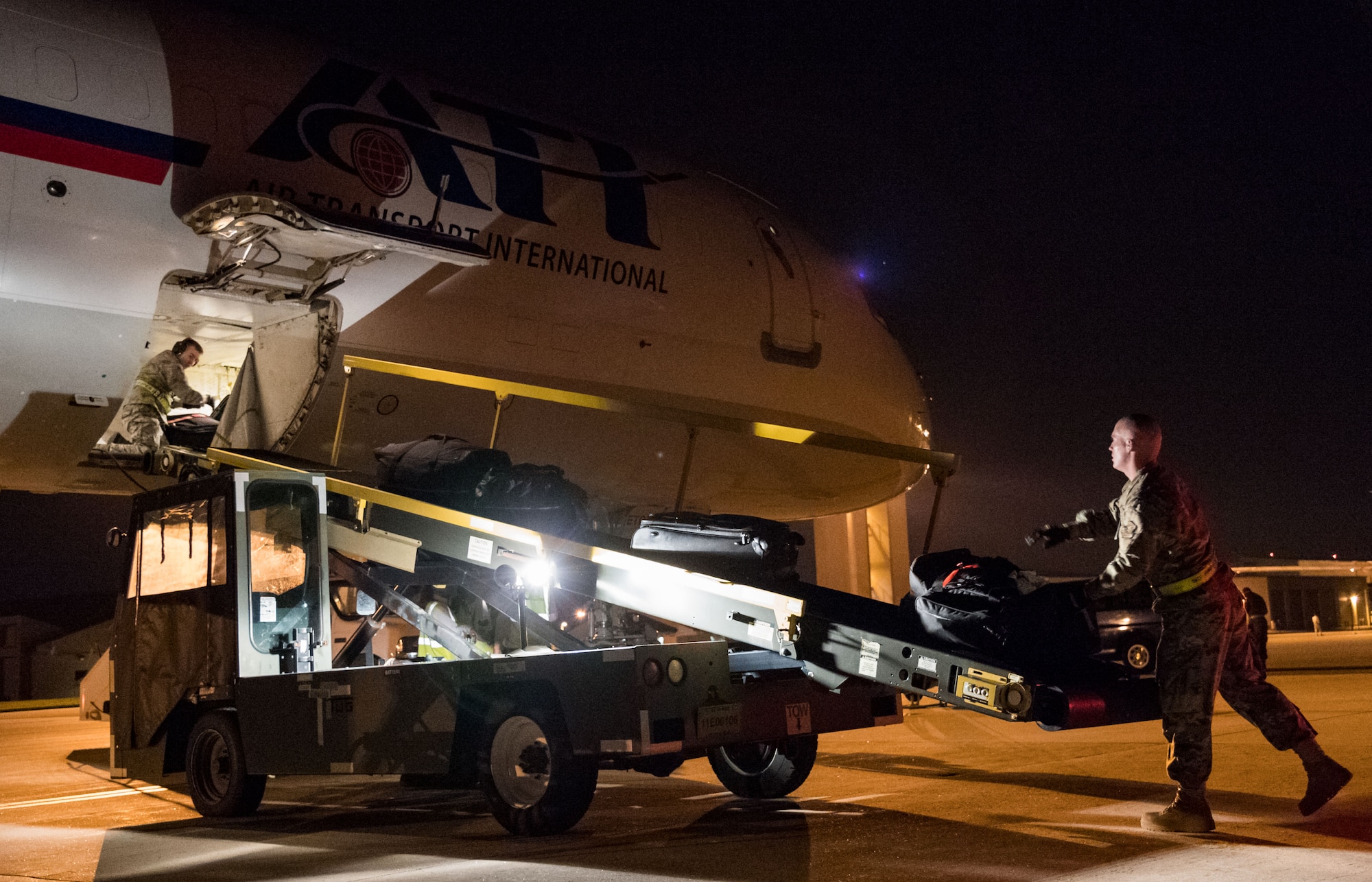 Passenger services personnel from the 436th Aerial Port Squadron load baggage into the lower cargo hold of an Air Transport International Boeing 757-200 Sept. 8, 2019, at Dover Air Force Base, Del. The ATI aircraft, part of the Civil Reserve Air Fleet program, was contracted to transport cargo and 30 Team Dover members to Fairchild AFB, Wash., participating in Mobility Guardian 2019. “Air Mobility Command’s commercial airlift partners are a vital part of our daily airlift missions around the world as well as our wartime effort,” said Maj. Adam Crane, AMC Headquarters CRAF Branch Chief, Scott AFB, Ill. (U.S. Air Force photo by Roland Balik)