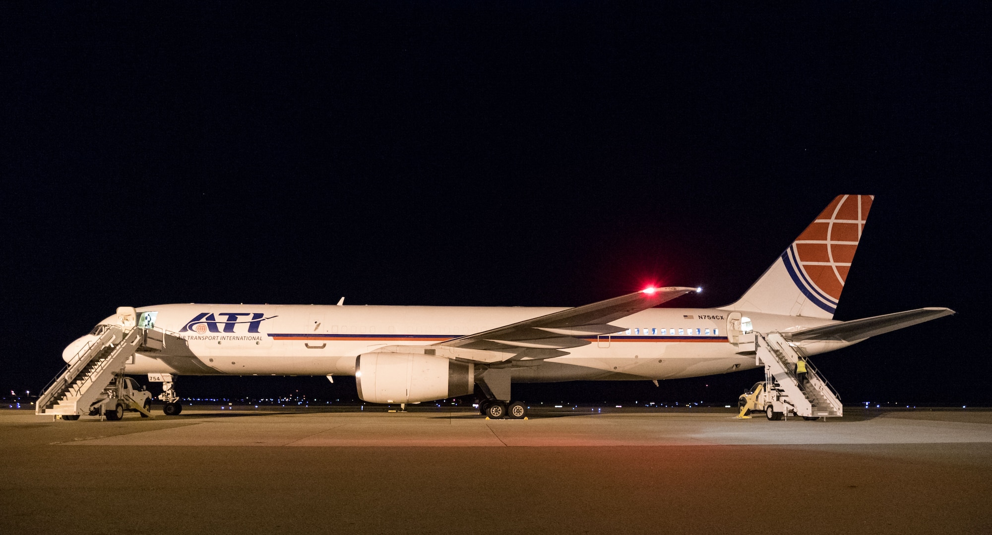 Step trucks sit parked at the forward and aft sections of an Air Transport International Boeing 757-200 Sept. 8, 2019, at Dover Air Force Base, Del. The ATI aircraft, part of the Civil Reserve Air Fleet program, was contracted to transport cargo and 30 Team Dover members to Fairchild AFB, Wash., participating in Mobility Guardian 2019. “This mission is multidimensional and will provide a greater understanding of the commercial airlift capabilities and requirements across Air Mobility Command and the commercial airlift enterprise,” said Maj. Adam Crane, AMC Headquarters CRAF Branch Chief, Scott AFB, Ill. (U.S. Air Force photo by Roland Balik)