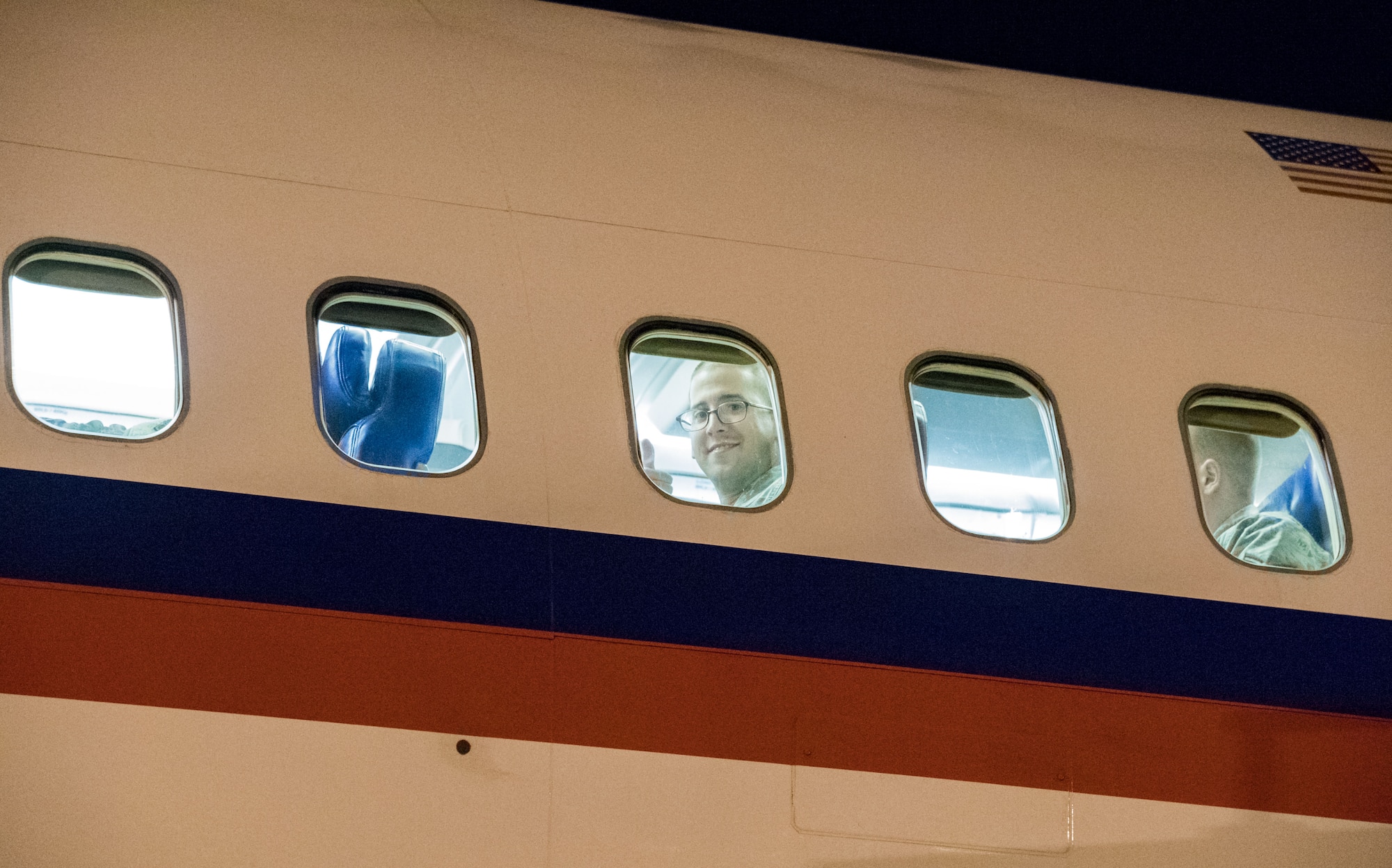 A Team Dover member smiles while looking out the window of an Air Transport International Boeing 757-200 Sept. 8, 2019, at Dover Air Force Base, Del. The ATI aircraft, part of the Civil Reserve Air Fleet program, was contracted to transport cargo and 30 Team Dover members to Fairchild AFB, Wash., participating in Mobility Guardian 2019. “In support of exercise Mobility Guardian 2019, Air Mobility Command contracted commercial aircraft to simulate activating CRAF marking the first time, in a long time, AMC has exercised a commercial component of its wartime plan,” said Maj. Adam Crane, AMC Headquarters CRAF Branch Chief, Scott AFB, Ill. (U.S. Air Force photo by Roland Balik)