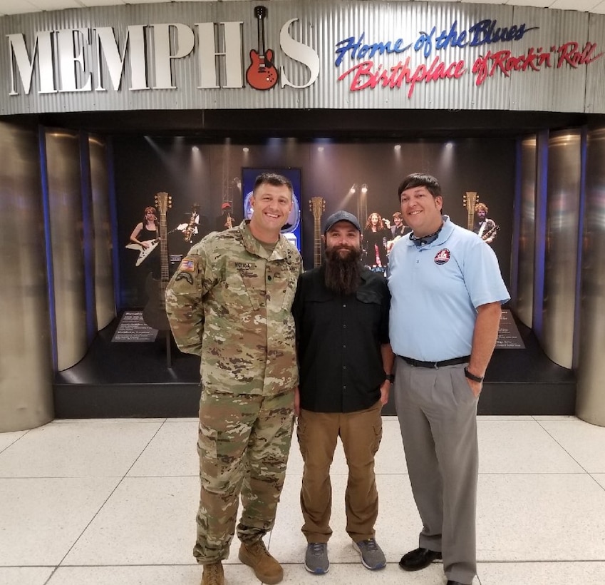 IN THE PHOTO, Memphis District Deputy Commander Lt. Col. Nathan Molica (left) and Jordan Bledsoe (right) greet Daniel Rocha upon his return home from a two year deployment with Task Force Essayons in Iraq. There he served as the Engineering Branch chief, a role for which he earned the Department of the Army Meritorious Civilian Service Award.