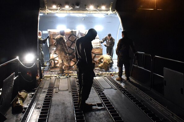 U.S. Air Force Staff Sgt. Curtis Taylor, 60th Aerial Port Squadron air terminal operation center senior controller, prepares to load cargo onto a McConnell Air Force Base, Kansas, KC-46 Pegasus Aug. 21, 2019, at Travis AFB, California. Taylor was part of the Travis AFB crew who met the visiting KC-46 and which mission it was to load life rafts for the U.S. Navy's USS Port Royal onto the aircraft and other cargo. (U.S. Air Force photo by Senior Airman Christian Conrad)