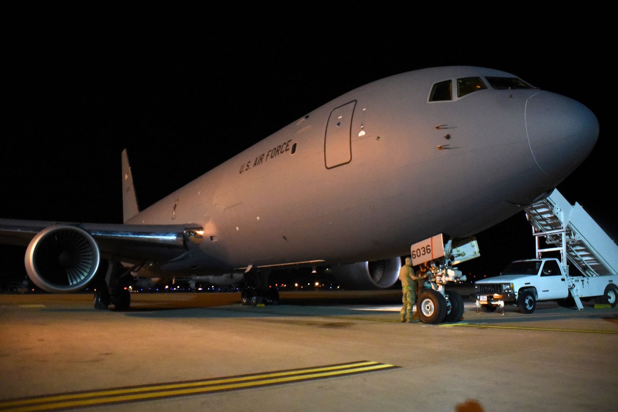 An Airman from McConnell Air Force Base, Kansas, conducts a post-flight check of a KC-46 Pegasus Aug. 21, 2019, at Travis AFB, California. The KC-46 aircrew coordinated with Travis' 60th Aerial Port Squadron during the trip, enlisting their help in loading supplies aboard the aircraft. (U.S. Air Force photo by Senior Airman Christian Conrad)