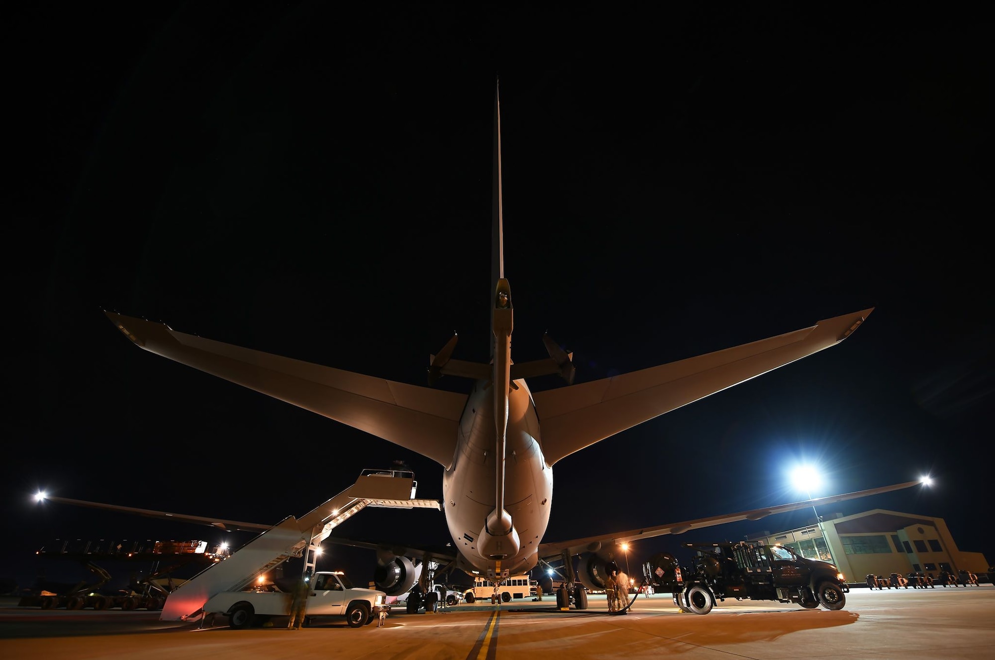 U.S. Airmen from McConnell Air Force Base, Kansas, and Travis AFB, California, engage in post-flight and cargo-loading protocol, respectively, Aug. 21, 2019, at Travis AFB. The cargo load was the first time Airmen from Travis' 60th Aerial Port Squadronworked with the new KC-46 PEgasus aircraft. (U.S. Air Force photo by Senior Airman Christian Conrad)