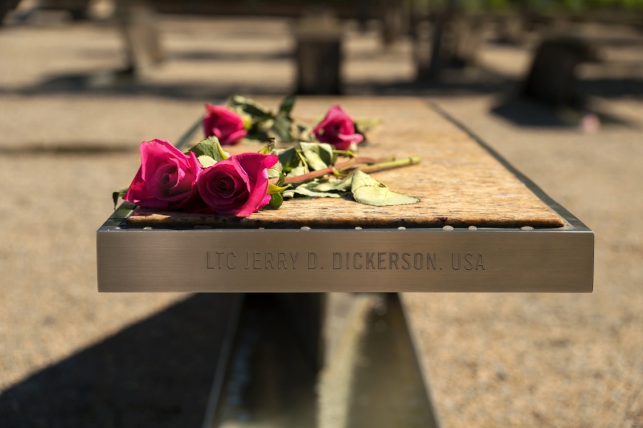 Flowers rest on an engraved bench at the National Pentagon 9/11 Memorial.