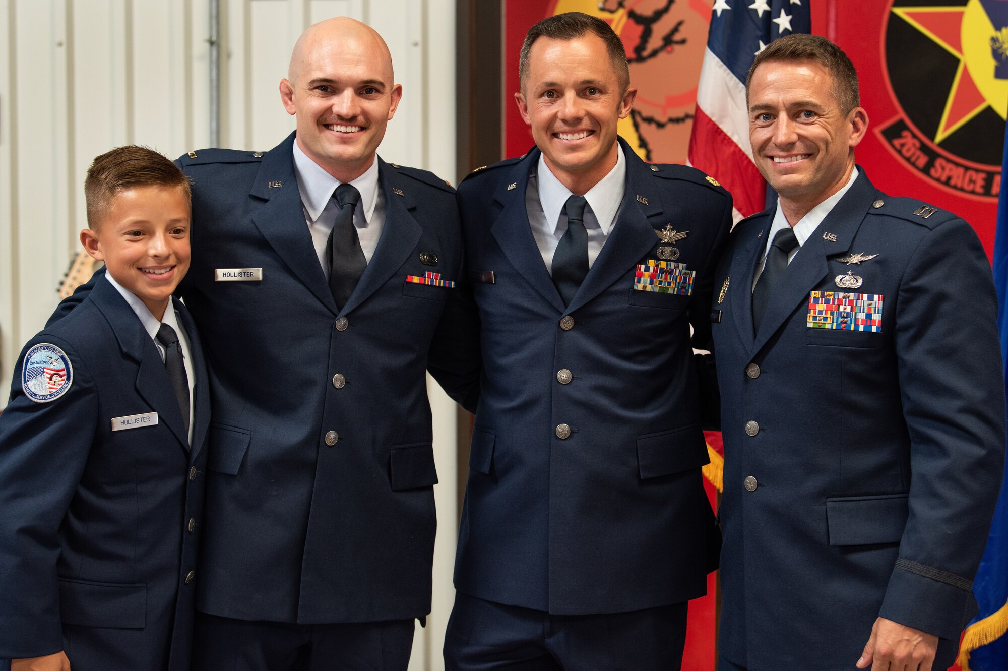 The three Hollister brothers, Taylor (second from left), Scott (middle), Ryan and Scott’s son, Trey (left), pose for a photo together during Scott’s promotion ceremony Sept. 8, 2019.