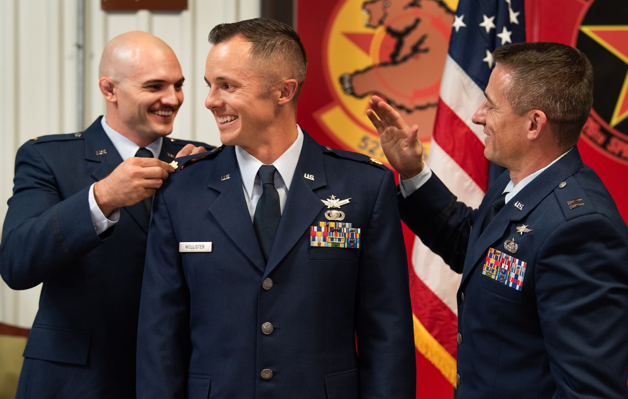 Maj. Scott Hollister’s brothers, Taylor (left) and Ryan (right) pin on his new rank during Scott’s promotion ceremony Sept. 8, 2019.