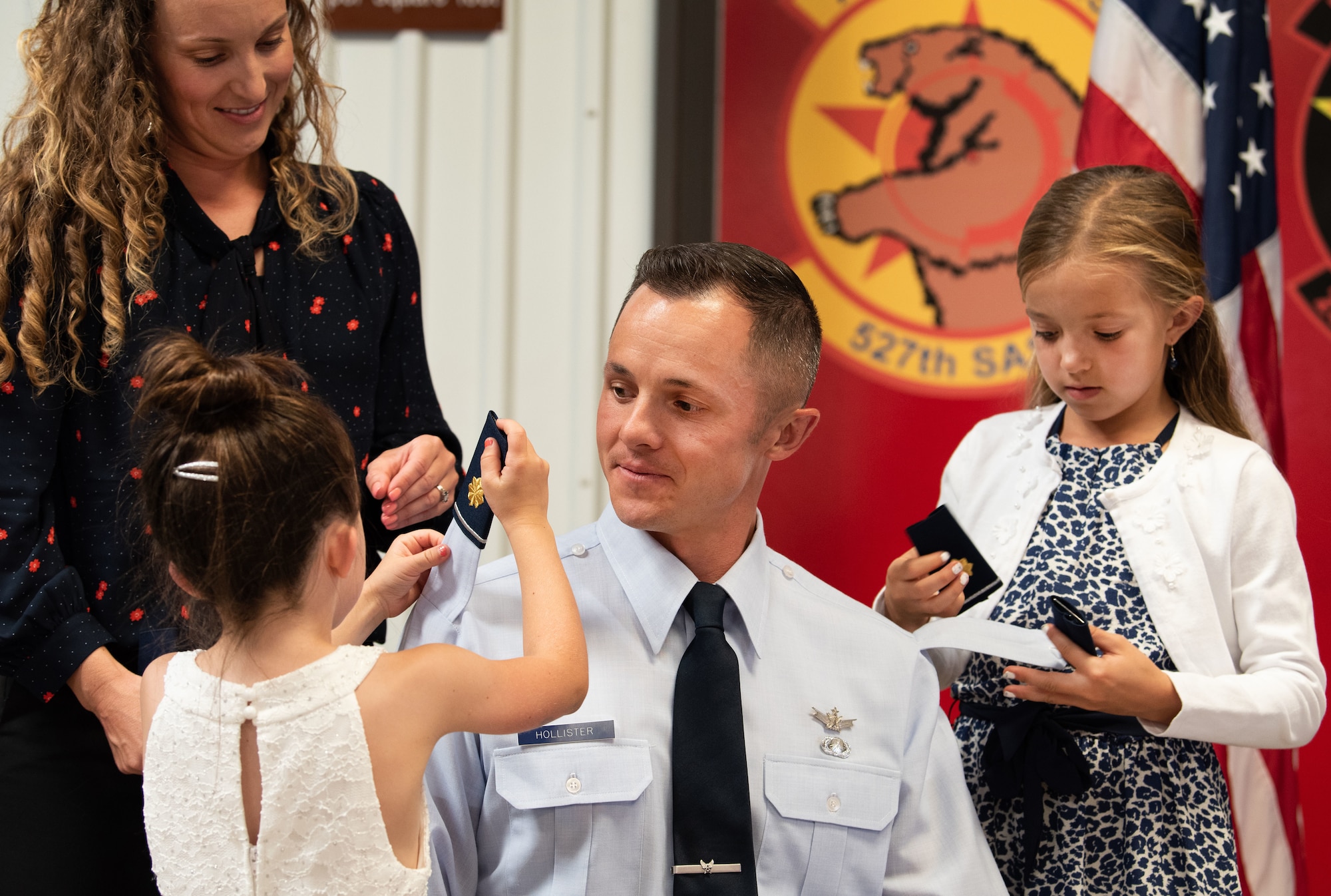 Maj. Scott Hollister’s family members put on his new rank during a promotion ceremony Sept. 8, 2019.