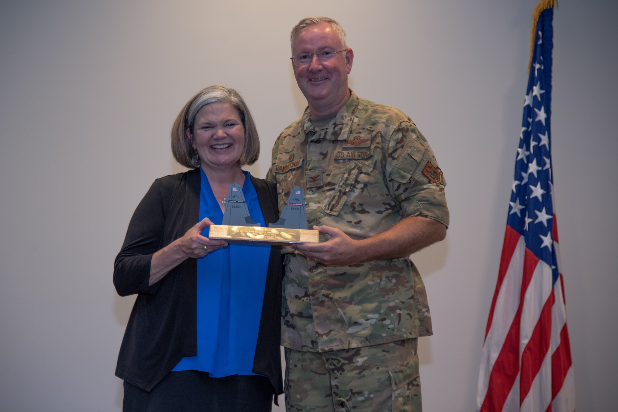 Col. Jeff Van Dootingh, 403rd Wing commander, presented a twin-tail flash token of appreciation to Kristen Christy, the 2018 Air Force Spouse of the Year, Sept. 8, 2019 at Keesler Air Force Base, Mississippi. The 403rd Wing held its tactical pause during their September Unit Training Assembly as they hosted Christy during their commander’s calls. (U.S. Air Force photo by Staff Sgt. Shelton Sherrill)