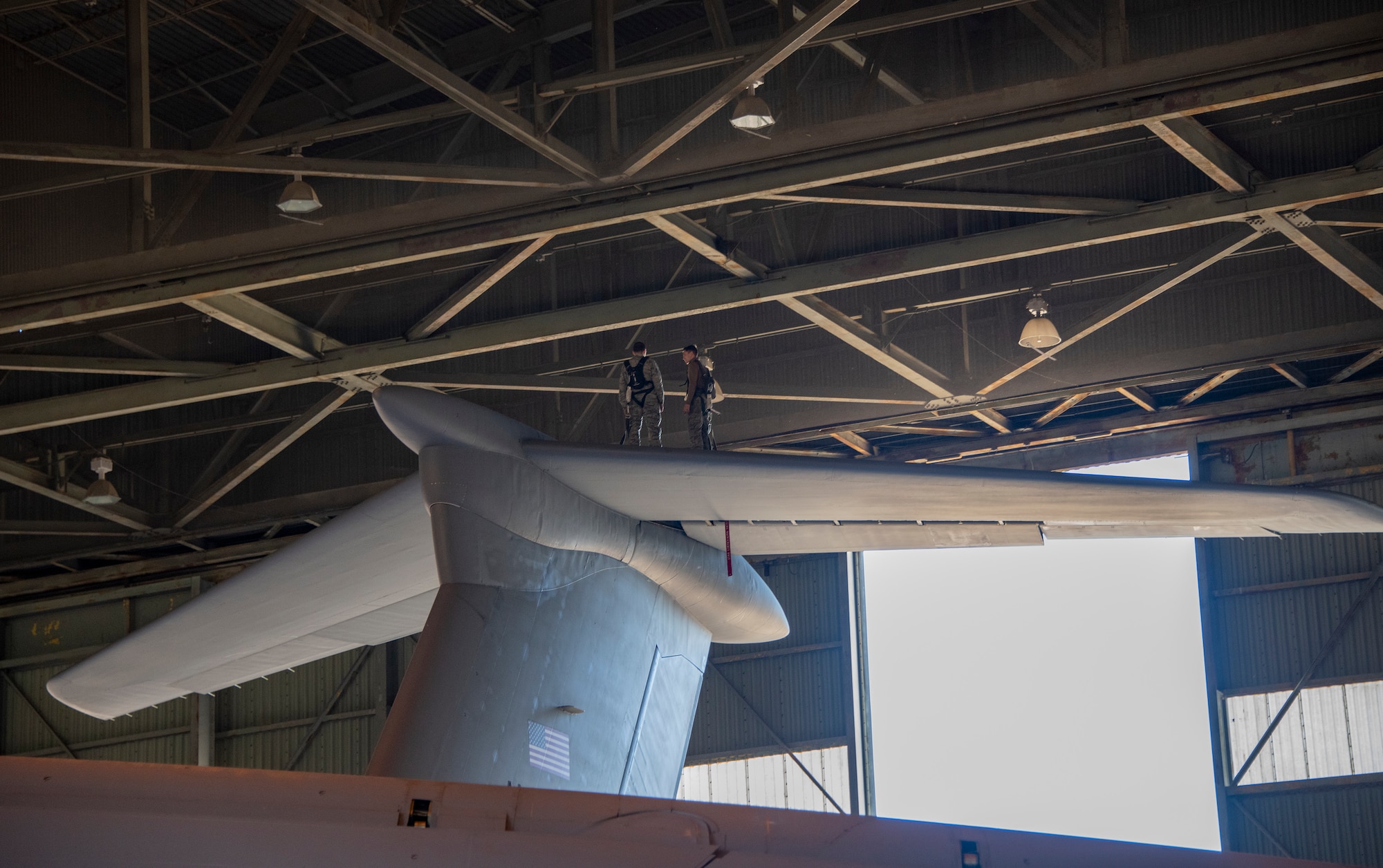 U.S. Air Force aircraft maintenance crews work on top of a C-5M Super Galaxy t tail, Sept. 6, 2019 hangar 818, at Travis Air force Base, California. The top of a C-5M Super Galaxy, the military’s largest aircraft, measures 65 feet, 1 inch. (U.S. Air Force photo by Heide Couch)