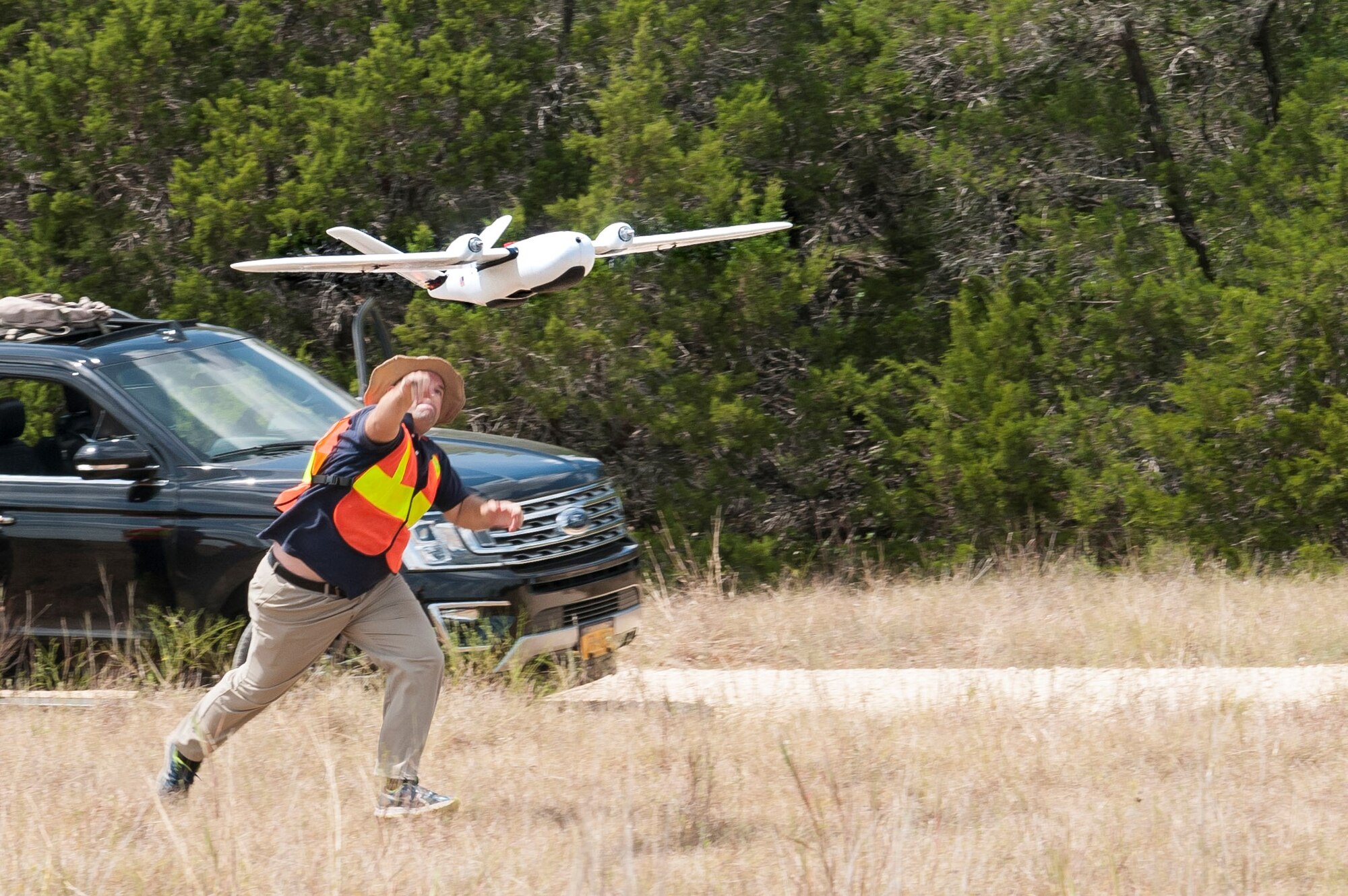 Ethan Jacobs, unmanned aerial system engineer, launches a UAS during a field test Sept. 4 at Camp Bullis, Texas. The UAS was equipped with Light Detection and Ranging, multi-spectral sensors and machine-learning algorithms to map, survey and inventory habitat for the golden-cheeked warbler. The field test will help the Air Force determine if UAS technology can characterize habitat better, faster and cheaper than current methods.