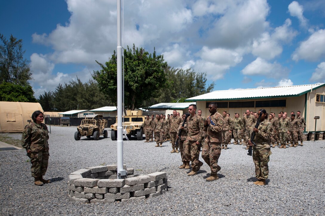 U.S. Air Force Airmen from the 475th Expeditionary Air Base Squadron conduct a flag-raising ceremony at Camp Simba, Kenya, Aug. 26, 2019. The 475th EABS raised the flag for the first time since the base operating support-integrator mission started in 2017, signifying the change from tactical to enduring operations. (U.S. Air Force photo by Staff Sgt. Lexie West)