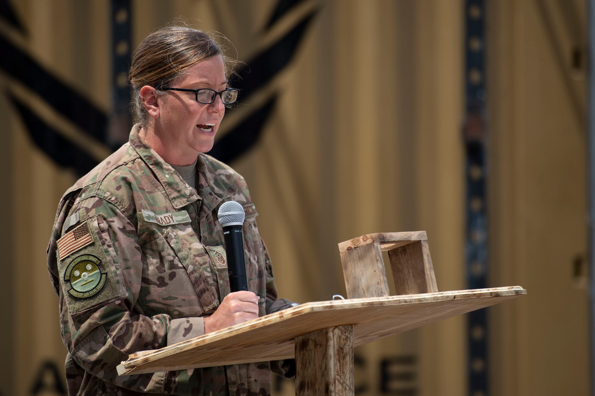 U.S. Air Force Master Sgt. Shannon Brady, 475th Expeditionary Air Base Squadron first sergeant, speaks about the history and symbolism of the American flag at a ceremony at Camp Simba, Kenya, Aug. 26, 2019. The 475th EABS raised the flag for the first time since the base operating support-integrator  mission started in 2017, signifying the change from tactical to enduring operations. (U.S. Air Force photo by Staff Sgt. Lexie West)