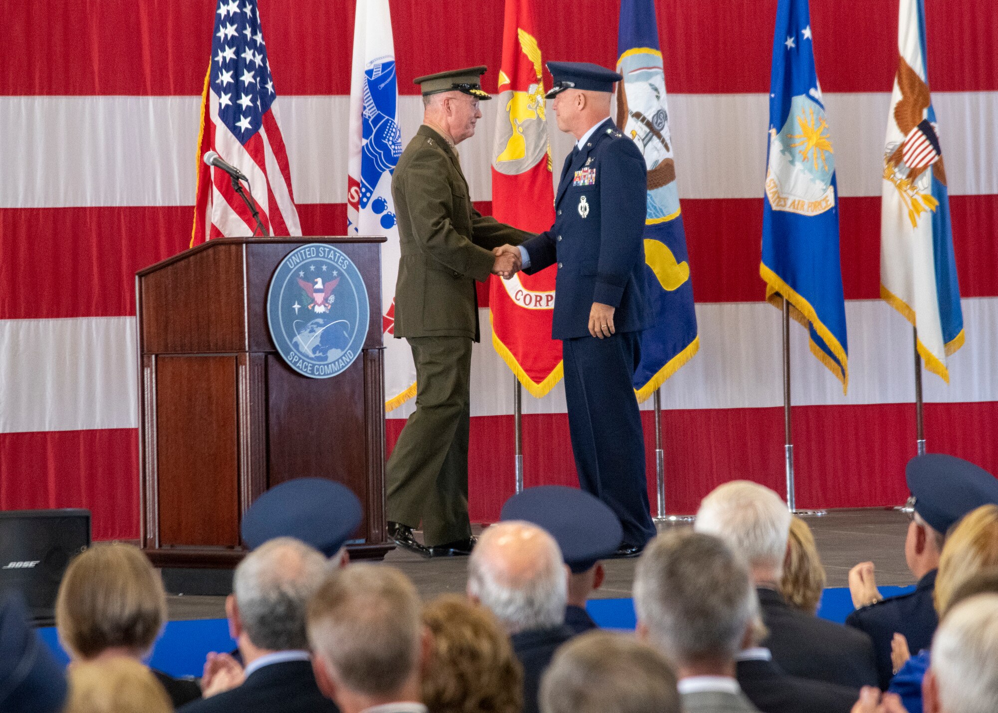 Marine Corps Gen. Joe Dunford, chairman of the Joint Chiefs of Staff, introduces Air Force Gen. John W. Raymond, commander, U.S. Space Command and Air Force Space Command, during the USSPACECOM Recognition and Establishment Ceremony at Peterson Air Force Base, Colorado Sept. 9, 2019.