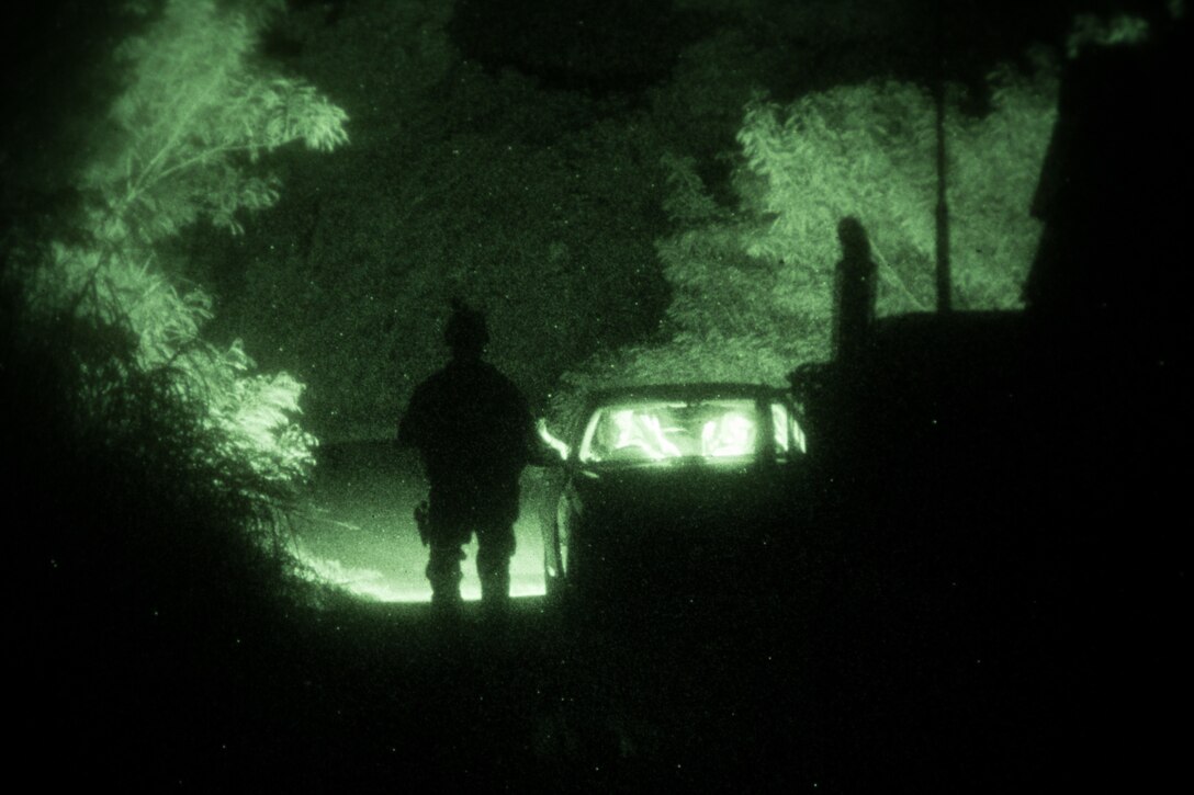 A U.S. Marine military policeman with 3rd Law Enforcement Battalion, III Marine Expeditionary Force Information Group approaches a vehicle at an entry control point during a training simulation at the Central Training Center, Okinawa, Japan, Aug. 25, 2019. 3rd LE Battalion Marines implemented ECPs around a town during a mission that was part of their Marine Corps Combat Readiness Evaluation.