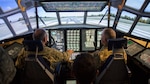 Col. Hugo Parentini, Uruguayan Air Force, and Col. Stephen Gwinn, 103rd Airlift Wing Commander, operate the wing's C-130H Hercules Multi-Mission Crew Trainer (MMCT) during a State Partnership Program visit to Bradley Air National Guard Base, East Granby, Conn. Aug. 15, 2019.