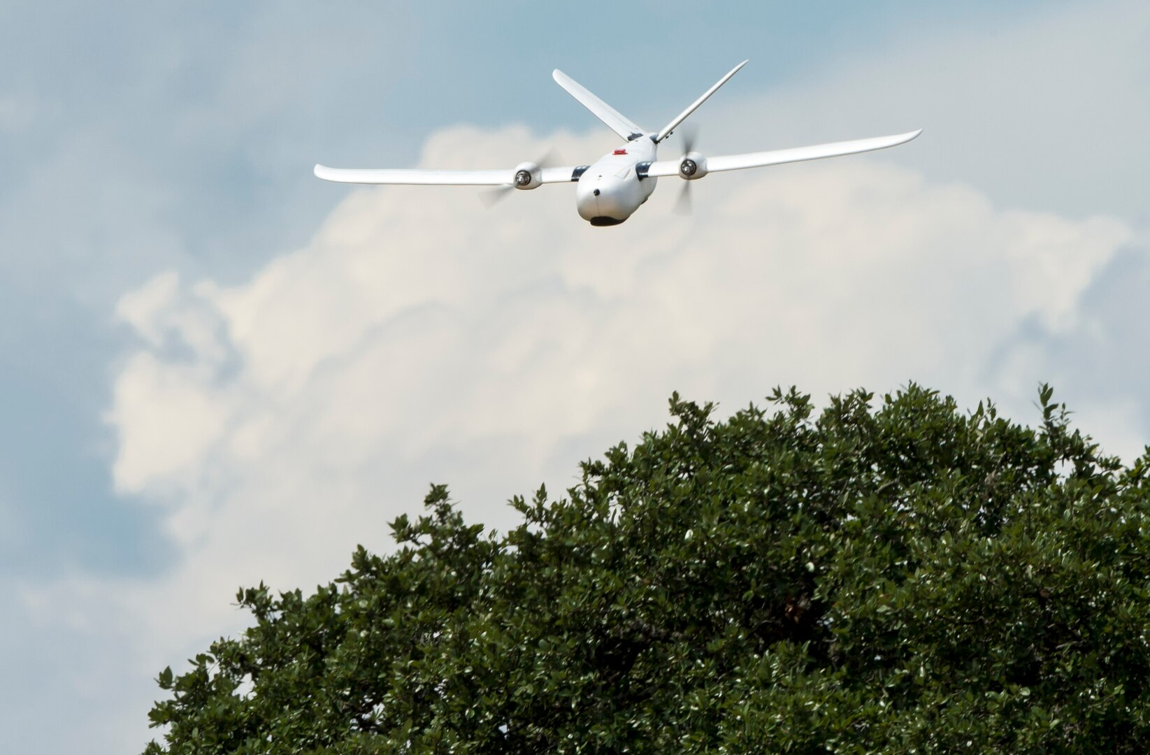 An unmanned aerial system flies over Joint Base San Antonio-Camp Bullis during a field test Sept. 4. The UAS was equipped with Light Detection and Ranging, multi-spectral sensors and machine-learning algorithms to map, survey and inventory habitat for the golden-cheeked warbler. The field test will help the Air Force determine if UAS technology can characterize habitat better, faster and cheaper than current methods.