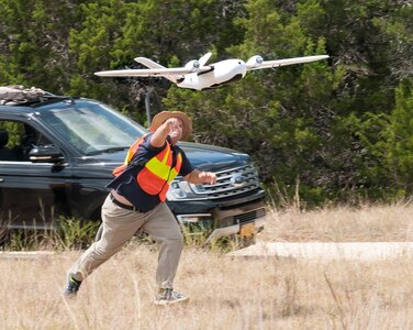 Ethan Jacobs, unmanned aerial system engineer, launches a UAS during a field test Sept. 4 at Joint Base San Antonio-Camp Bullis. The UAS was equipped with Light Detection and Ranging, multi-spectral sensors and machine-learning algorithms to map, survey and inventory habitat for the golden-cheeked warbler. The field test will help the Air Force determine if UAS technology can characterize habitat better, faster and cheaper than current methods.