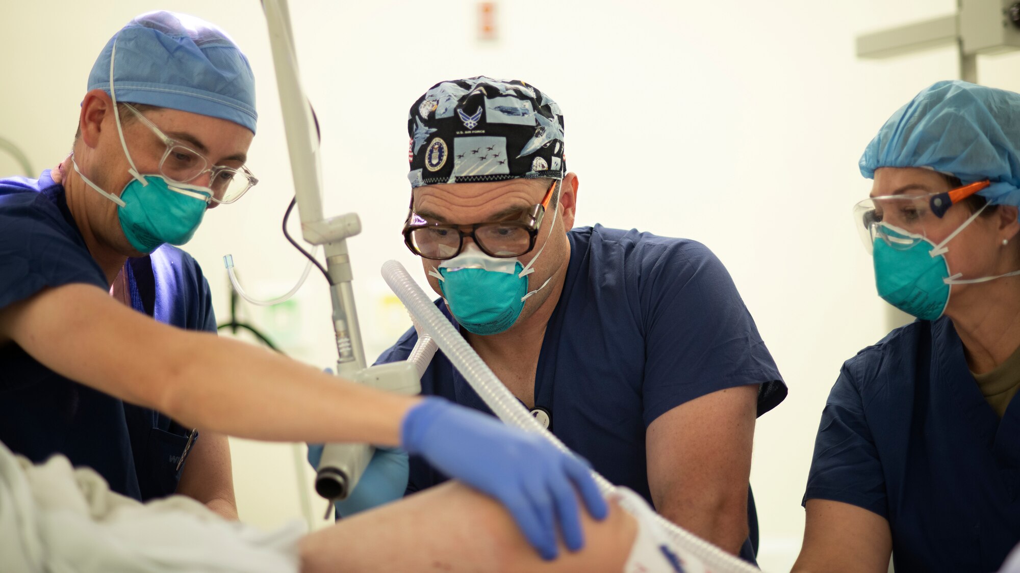 Lt. Col. (Dr.) Shannon Buck, Col. (Dr.) Chad Hivnor and Lt. Col. (Dr.) Shannan McCann, 59th Medical Specialty Squadron dermatologists, perform fractionated carbon dioxide laser surgery