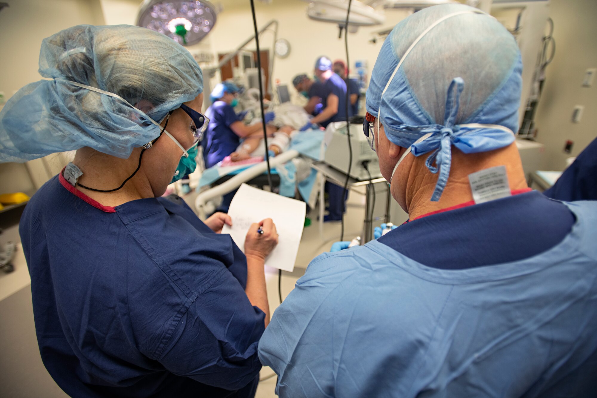 An operating room team performs surgery on retired U.S. Army Capt. Katie Blanchard