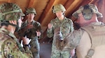 Soldiers from the 25th Infantry Regiment sniper teams receives some pointers from a member of the sniper team from the Illinois National Guard’s 2nd Battalion, 130th Infantry Regiment during Rising Thunder 19.