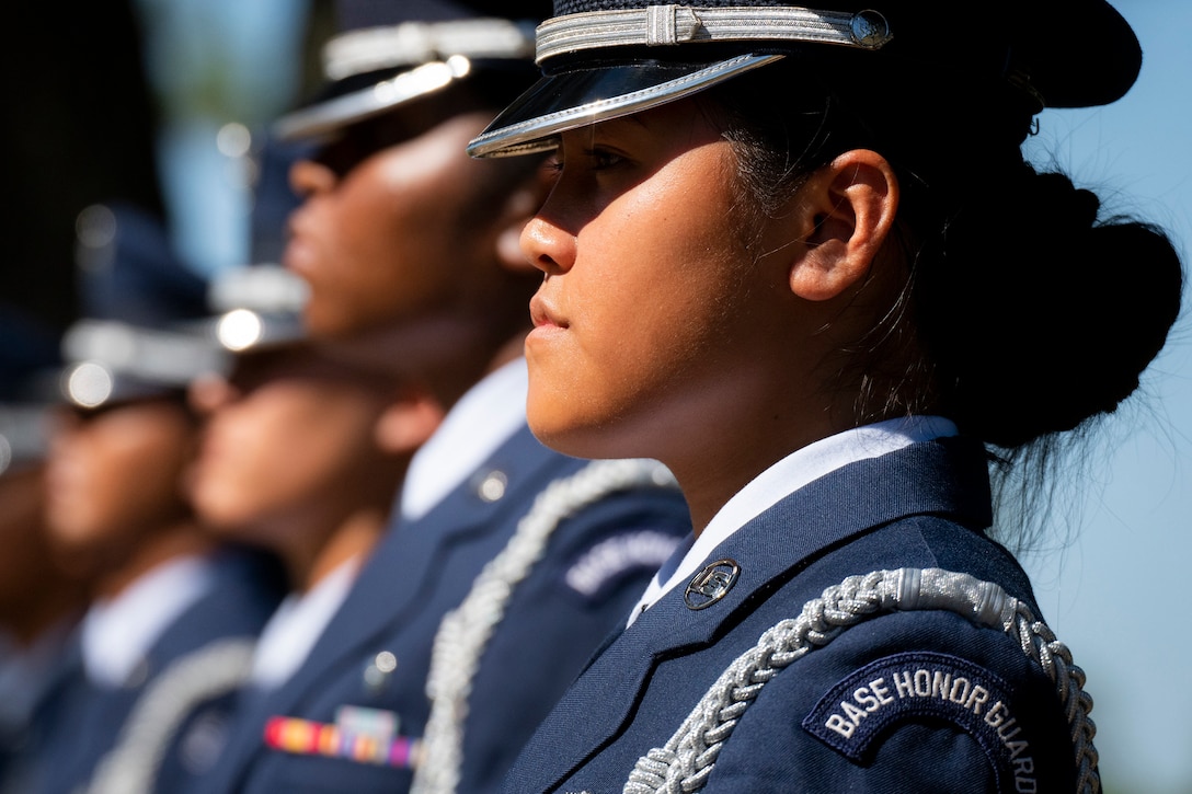 A row of airman stand at attention.