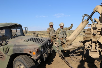 Sgt. First Class Brian Jackson from the 1844th Transportation Company uses a "halt" hand signal as his recovery vehicle's towbar lines up with the humvee during a training lane in Rising Thunder 2019.