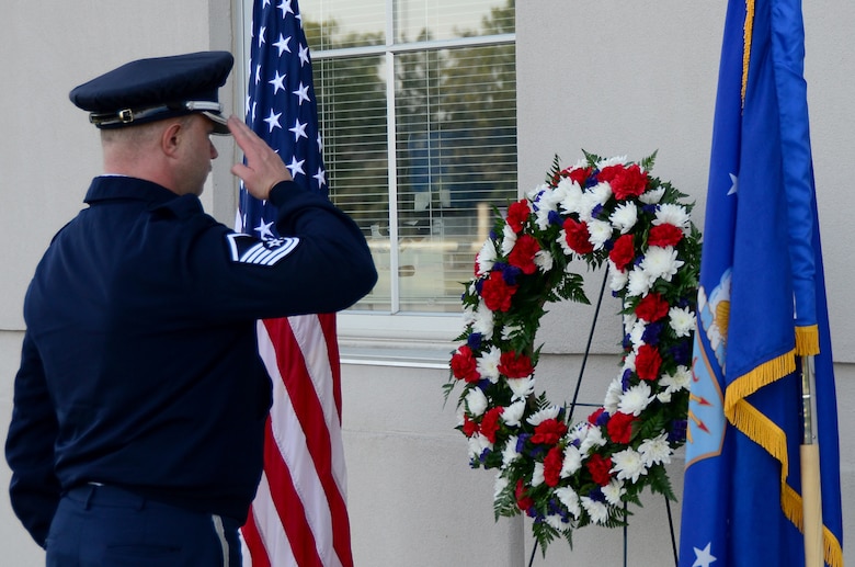 Master Sgt. Shawn McKellop, 445th Airlift Wing Honor Guard member, lays a wreath of the base of the Maj. LeRoy W. Homer, Jr. Operations Building, Sept. 11, 2019, during a Patriot Day ceremony. Maj. LeRoy Homer was the First Officer on United Airlines Flight 93 that crashed in Shanksville, Pa. at 10:03 a.m. Sept. 11, 2001. Homer was a member of the 445th Airlift Wing’s 356th Airlift Squadron from 1995 to 2000.