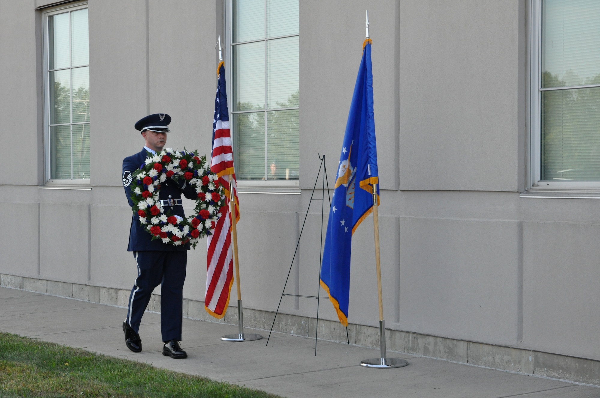 Master Sgt. Shawn McKellop, 445th Airlift Wing Honor Guard member, lays a wreath of the base of the Maj. LeRoy W. Homer, Jr. Operations Building, Sept. 11, 2019, during a Patriot Day ceremony. Maj. LeRoy Homer was the First Officer on United Airlines Flight 93 that crashed in Shanksville, Pa. at 10:03 a.m. Sept. 11, 2001. Homer was a member of the 445th Airlift Wing’s 356th Airlift Squadron from 1995 to 2000.
