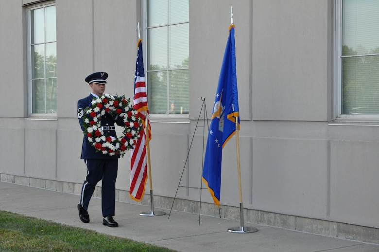 Master Sgt. Shawn McKellop, 445th Airlift Wing Honor Guard member, lays a wreath of the base of the Maj. LeRoy W. Homer, Jr. Operations Building, Sept. 11, 2019, during a Patriot Day ceremony. Maj. LeRoy Homer was the First Officer on United Airlines Flight 93 that crashed in Shanksville, Pa. at 10:03 a.m. Sept. 11, 2001. Homer was a member of the 445th Airlift Wing’s 356th Airlift Squadron from 1995 to 2000.