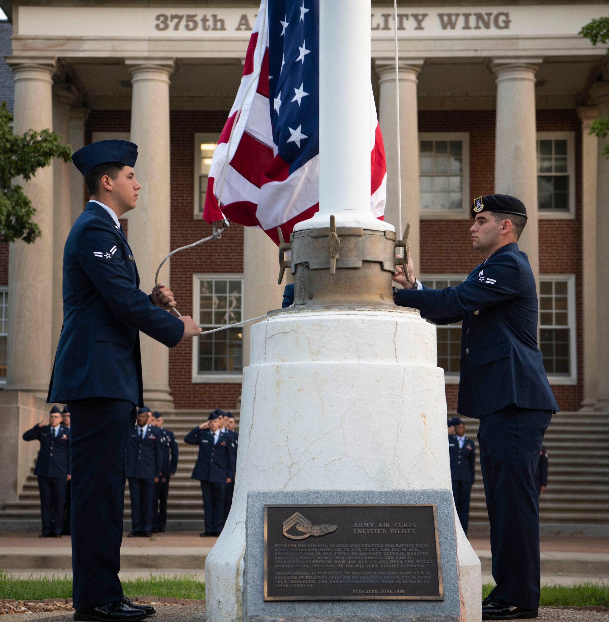 Airmen raise flag to half-staff