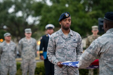 Airman 1st Class Jalen Anderson folds a flag during a 9/11 remembrance ceremony Sept. 11 at Joint Base San Antonio-Randolph. The event honored those who lost their lives during terrorist attacks in New York City, Washington D.C. and Pennsylvania 18 years ago.