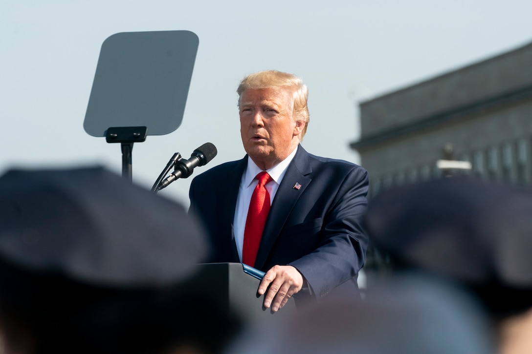 President Donald J. Trump speaks into a microphone.