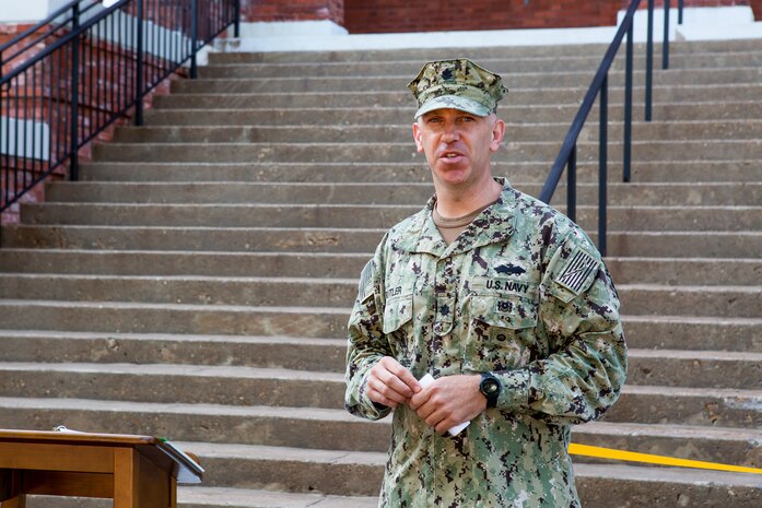 Norfolk Naval Shiphard's Public Works Officer Cmdr. William Butler speaks at the ribbon cutting of Bldg. M-32 Aug. 22.