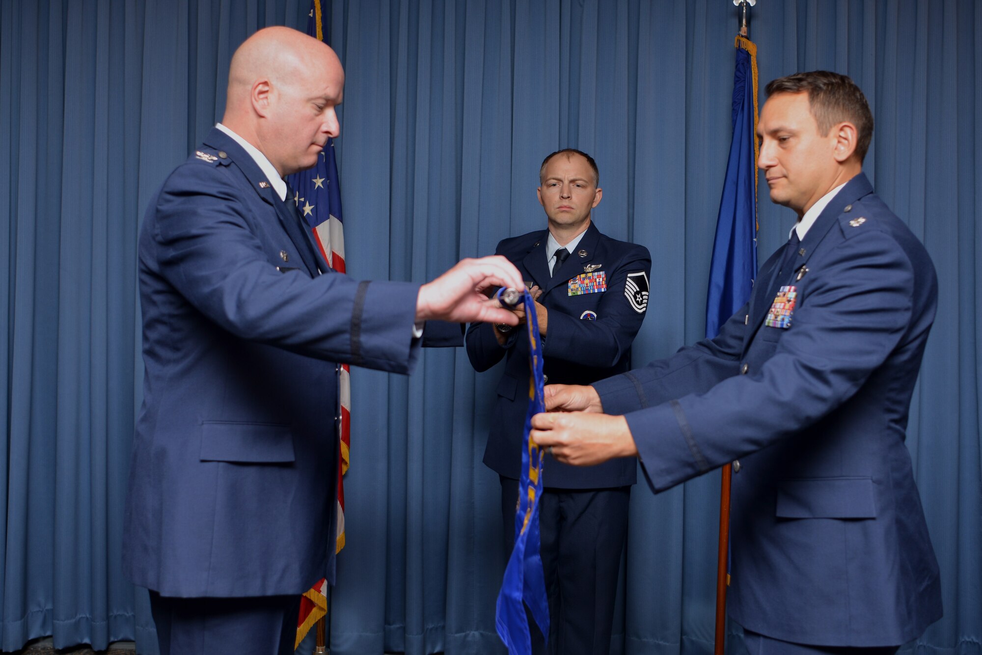 U.S. Air Force Lt. Col. Brian R. Dicks (right), 58th Operations Group Detachment Two commander, and U.S. Air Force Col. Richard Carrell, 58th Operations Group commander, unfurl the 58th OG Det. Two guidon during the 58th OG Det. Two activation and assumption of command ceremony at Kirtland Air Force Base, N.M., Aug. 23, 2019. The detachment will be responsible for validating training, ensuring appropriate facilities and equipment are available and standing up formal training for the rotary-wing personnel recovery platform for the new HH-60W Combat Rescue Helicopter. (U.S. Air Force photo by Staff Sgt. Dylan Nuckolls)