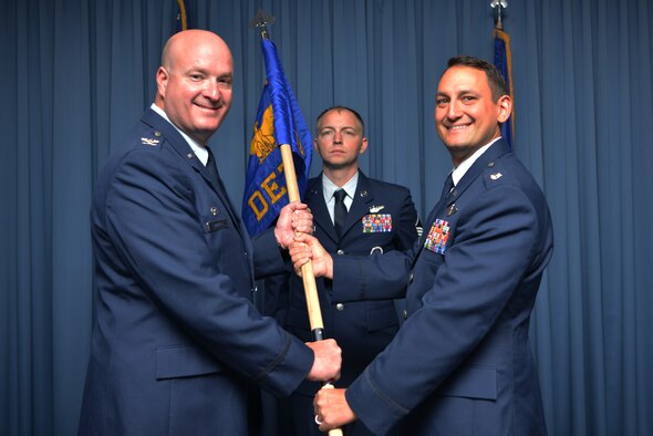 U.S. Air Force Lt. Col. Brian R. Dicks (right), 58th Operations Group Detachment Two commander, receives command of the 58th OG Det. Two from U.S. Air Force Col. Richard Carrell, 58th Operations Group commander, during the 58th OG Det. Two activation and assumption of command ceremony at Kirtland Air Force Base, N.M., Aug. 23, 2019. The detachment will be responsible for validating training, ensuring appropriate facilities and equipment are available and standing up formal training for the rotary-wing personnel recovery platform for the new HH-60W Combat Rescue Helicopter. (U.S. Air Force photo by Staff Sgt. Dylan Nuckolls)