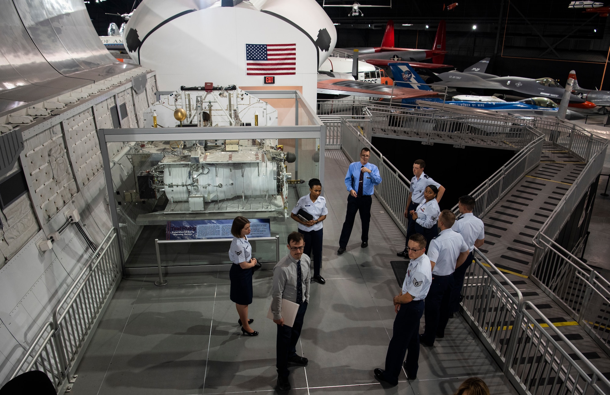 A group of Airmen from F.E. Warren Air Force Base, Wyo,. tour a space trainer at The National Museum of the U.S. Air Force Sept. 4, 2019, at Wright-Patterson Air Force Base, Ohio. The museum has four hangars dedicated to different eras of history within the Air Force, including the space gallery. (U.S. Air Force photo by Senior Airman Abbigayle Williams)