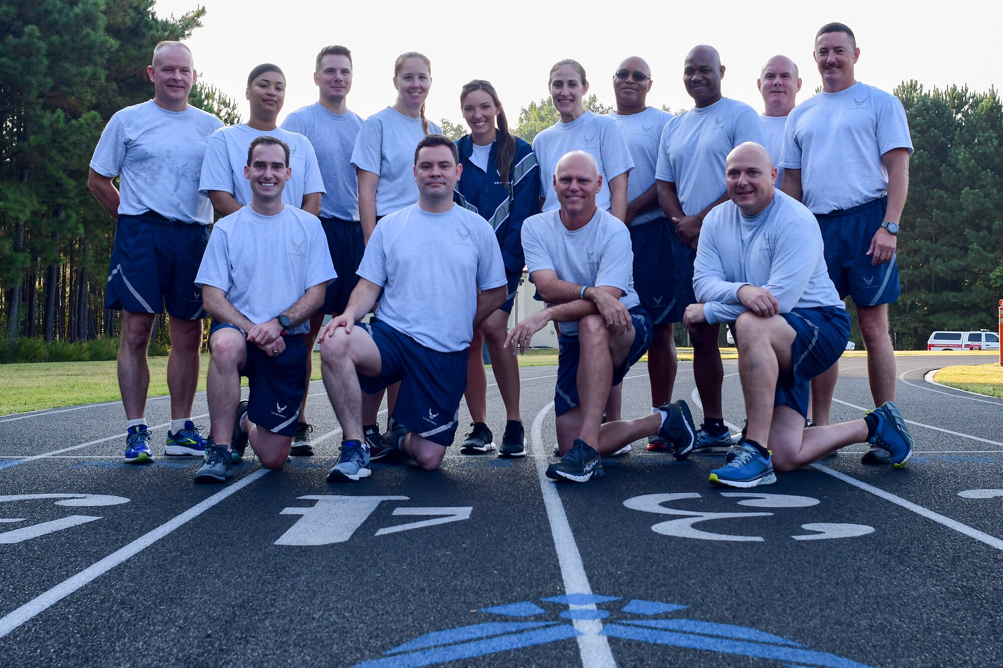A group of participants in this year's Sept. 11 Memorial Walk pose for a photo at the base track Sept. 11, 2019.