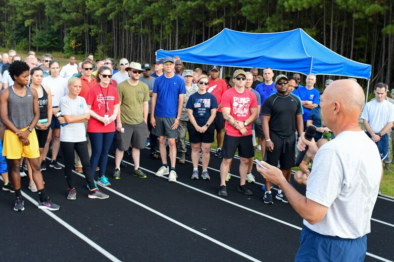 Brig. Gen. Richard Kemble, 94th Airlift Wing commander, gives the opening remarks at this year's Sept. 11 Memorial Walk at the base track, Sept. 11, 2019.